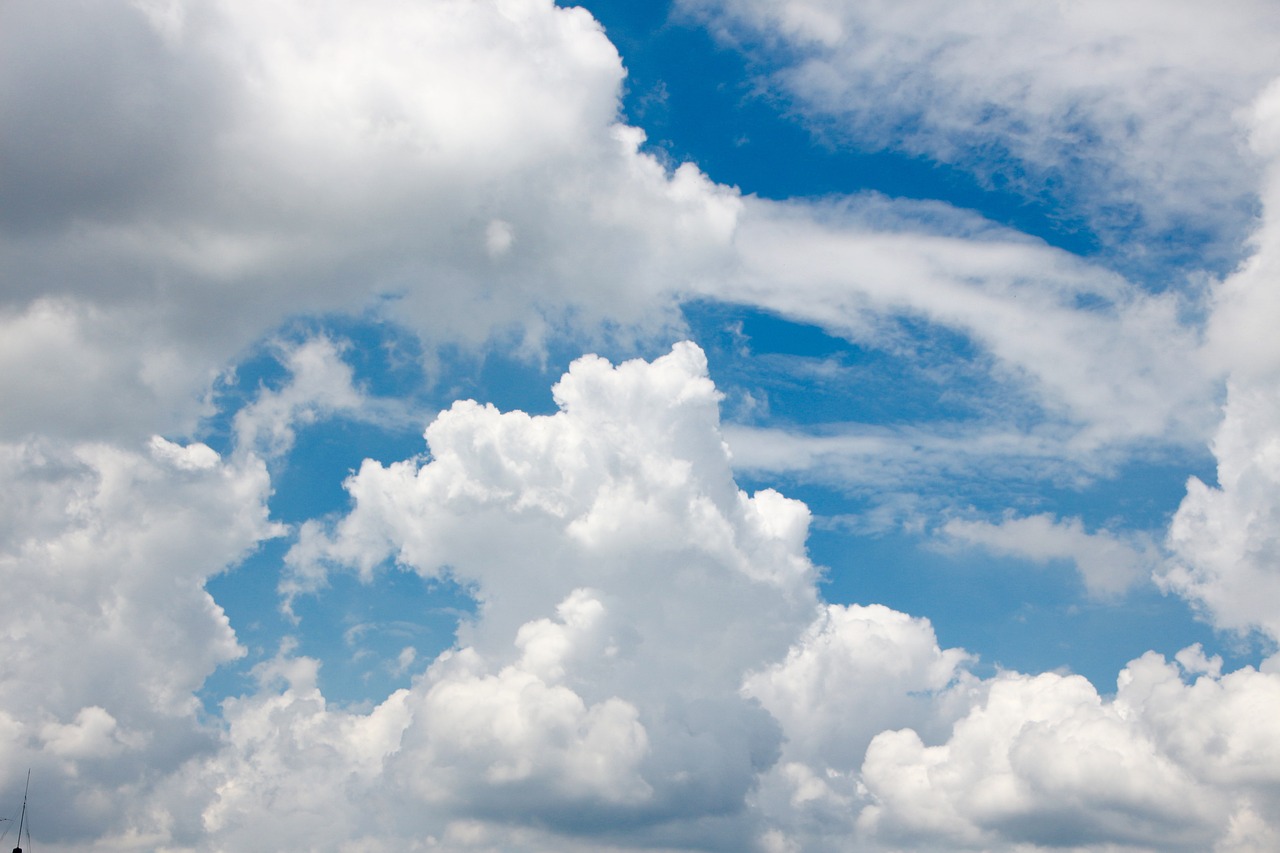 a blue sky with large white clouds